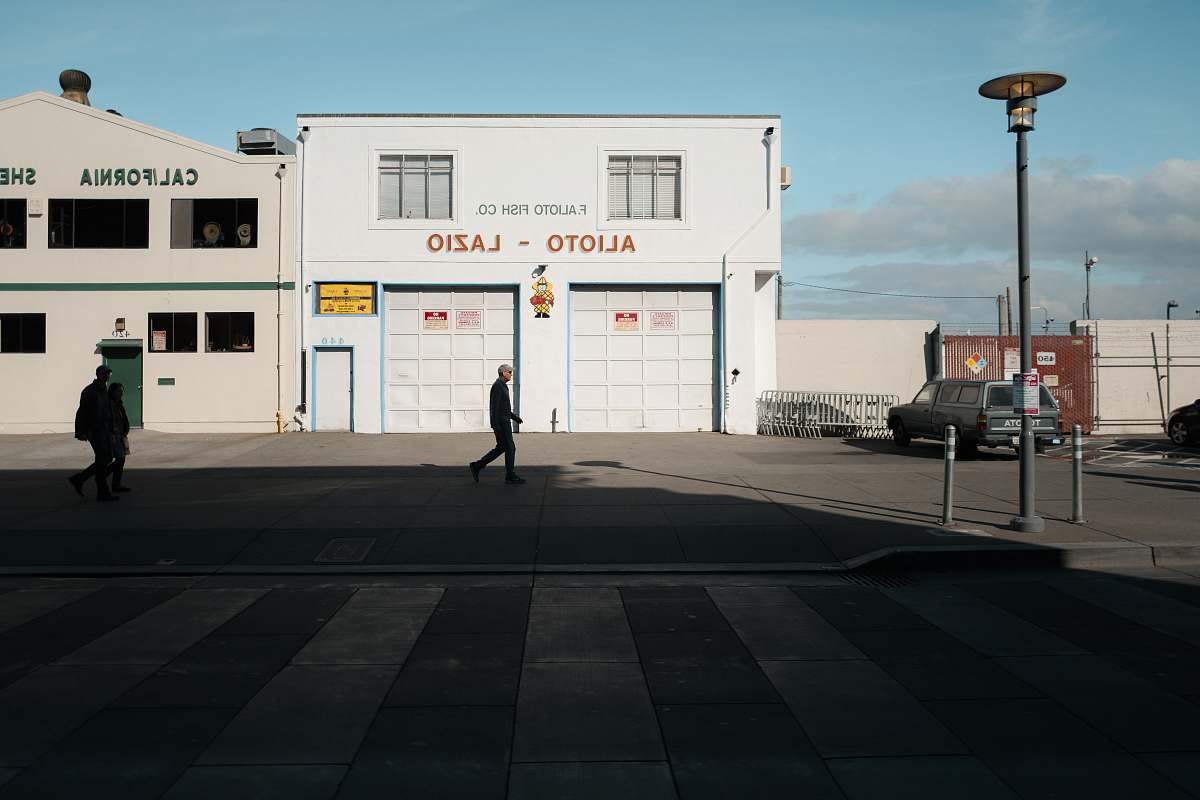 san francisco man walking in front of Alioto Lazio building united states